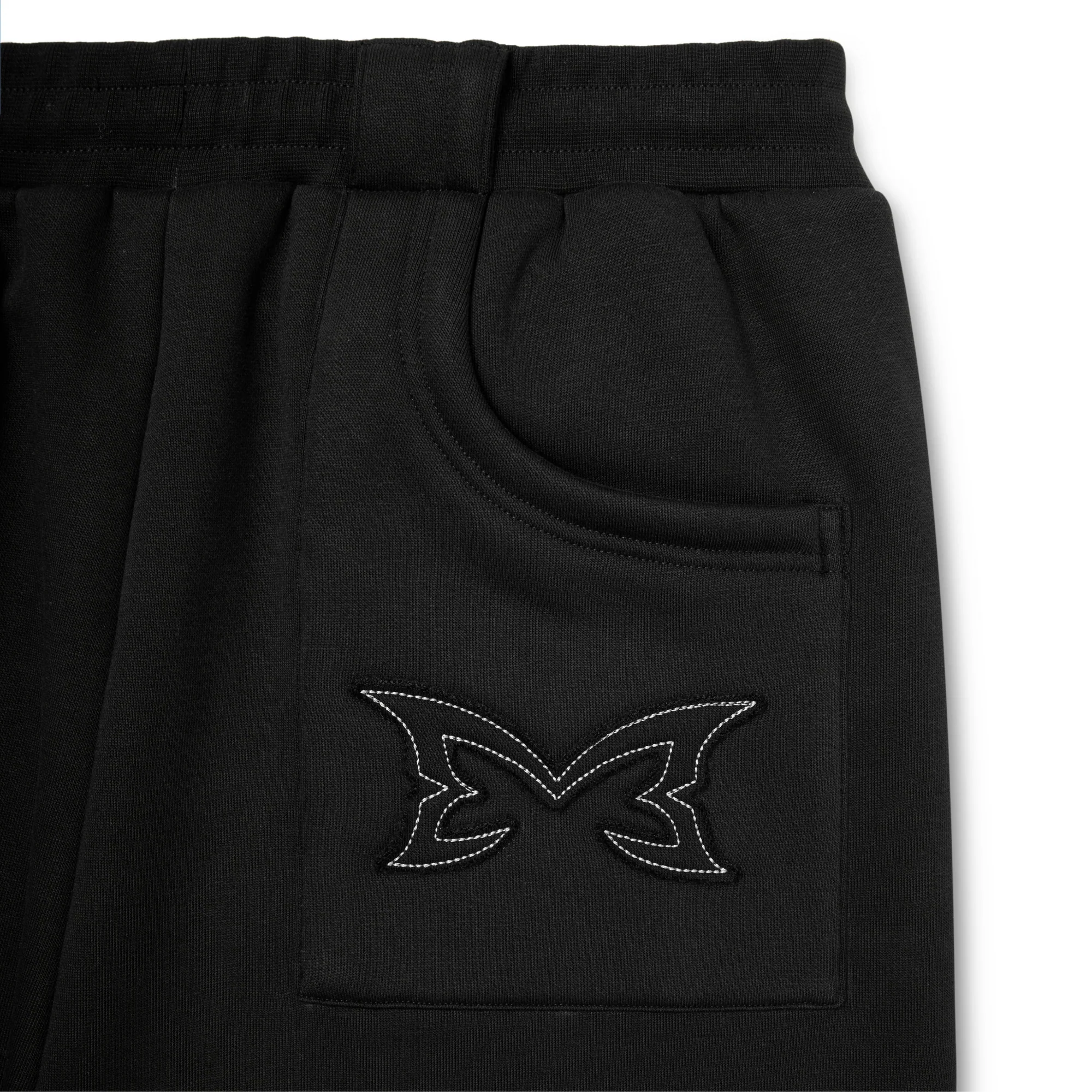 Black pants with a logo on the pocket against a white background